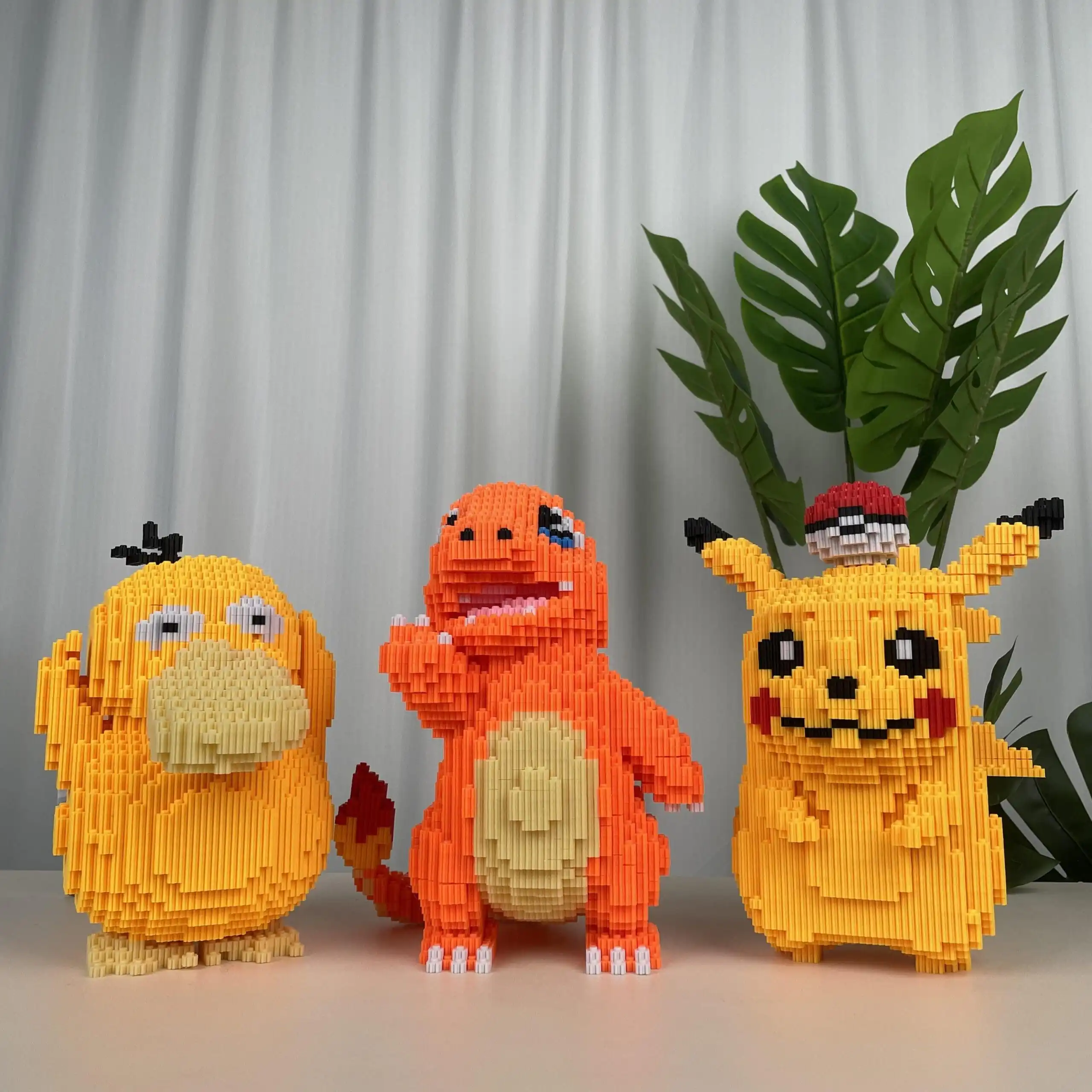 Three vibrant Brick Bear toys constructed from colorful building blocks, displayed in pixelated designs against a backdrop of light curtains and green foliage
