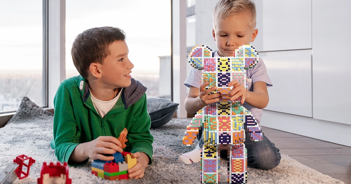 two boys playing with pixel bear toy set