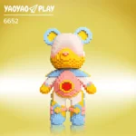 A ​​Brick Bear toy​​ with light blue ears, gradient pink-yellow face, and red heart chest, labeled "6652PCS" on a yellow backdrop.