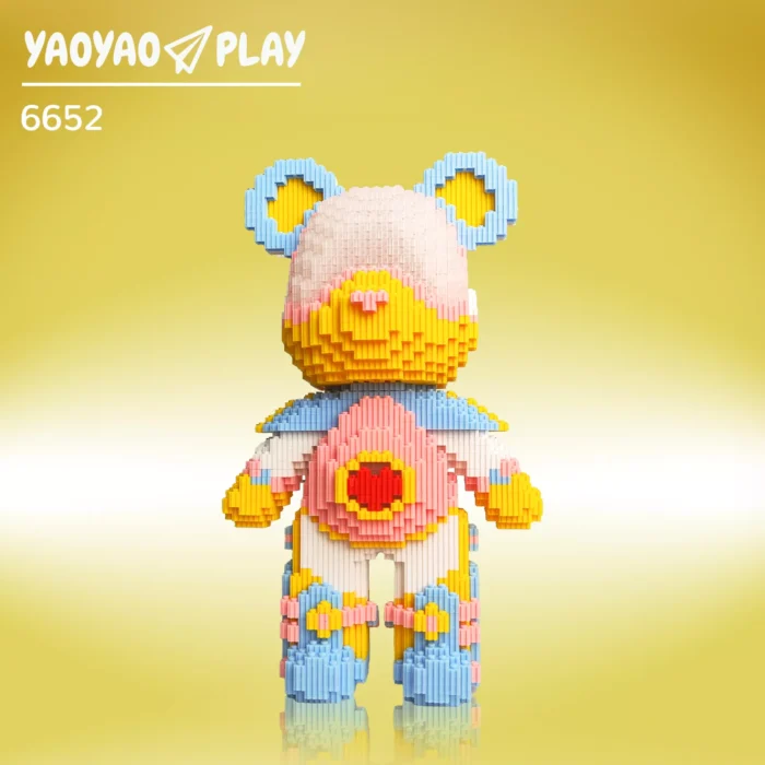 A ​​Brick Bear toy​​ with light blue ears, gradient pink-yellow face, and red heart chest, labeled "6652PCS" on a yellow backdrop.