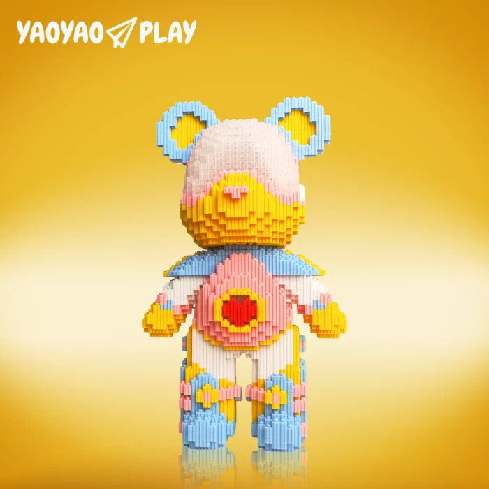 Constructed from 6,652 interlocking ​​building blocks​​, this ​​toy​​ showcases a gradient pink-to-yellow face, light blue ears with yellow centers, and a red heart emblem on its chest. Limbs feature alternating pink, yellow, and blue joints for dynamic contrast. The golden-yellow backdrop and "YAOYAO PLAY" branding highlight its child-friendly proportions and modular adaptability, ideal for hands-on builders.