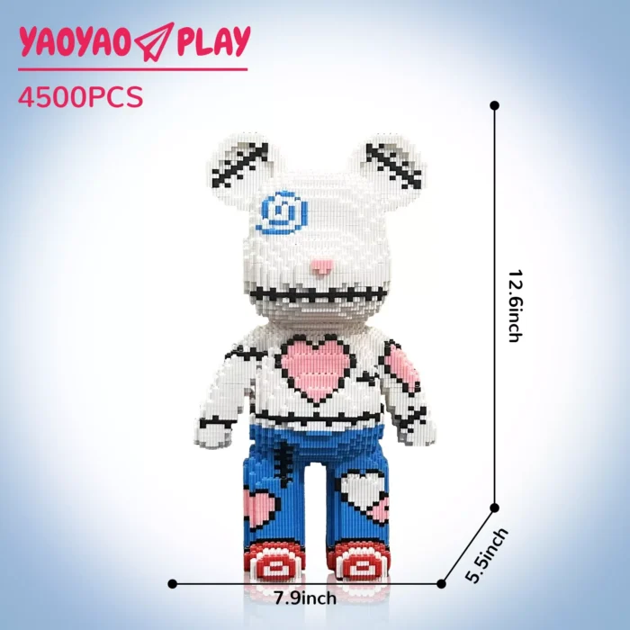 White block-built bear toy with blue swirl eye, pink heart torso, and red sneakers against gradient blue, labeled 'YA0YAO PLAY